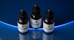 Three RuRestore 5% RU58841 Topical Formula bottles on reflective surface - UK hair loss treatment